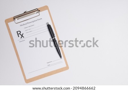 Empty medical prescription with a pen isolated. Ballpoint pen lying on medical prescription near phonendoscope in doctors office.