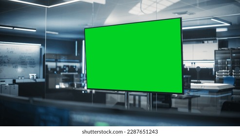 Empty Meeting Conference Room with Green Screen Mock Up TV Display. Establishing Shot in a Technologically Advanced Research and Development Office - Powered by Shutterstock