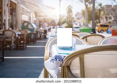 Empty Menu Frame With Space For Mockup Stands On Table Of Street Cafe