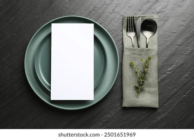 Empty menu, plates, cutlery, napkin and floral decor on black table, top view. Mockup for design - Powered by Shutterstock