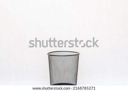 Empty mesh trash bin, garbage can on a white background.