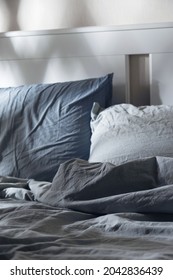 Empty Messy Bed With Pillows In The Moonlight. Darkness And Evening Rituals For Healthy Sleep.