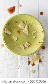 Empty And Messy Plate Of Nachos With Tortilla Chips Crumbs And Salsa