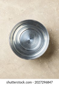 Empty Metal Bowl On A Beige Color Kitchen Table, Top View