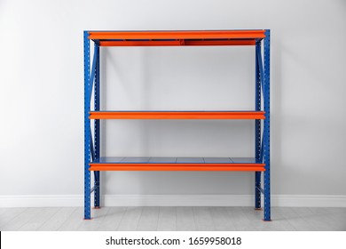 Empty Metal Shelving Unit Near Light Wall