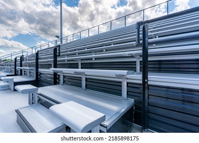 Empty Metal Stadium Bleacher Seats With Cloudy Sky.
