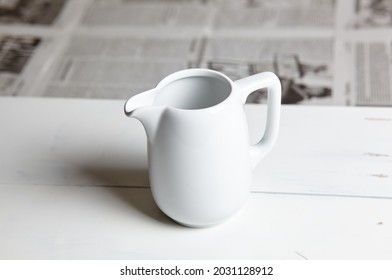 Empty Milk Jug On Wooden Background. Porcelain Sauce Boat, Pitcher, Creamer Or Ceramic Gravy Boat