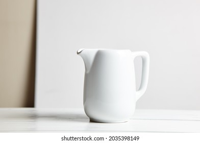 Empty Milk Jug On Wooden Background. Porcelain Sauce Boat, Pitcher, Creamer Or Ceramic Gravy Boat