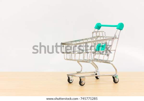 empty mini shopping cart on wood.\
blank small\
car supermarket on floor\
wooden.