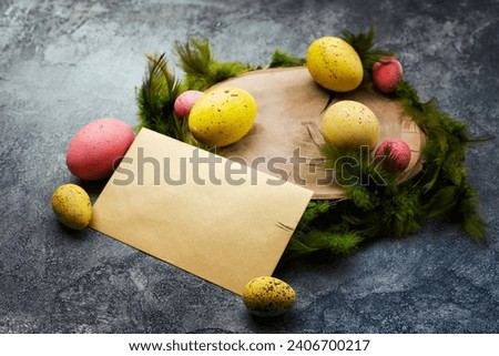 Empty mockup blank on a Easter background. Colorful eggs and feathers on the wooden stump. - Copyspace