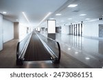 Empty modern airport terminal with a moving walkway (travelator) and blank billboards mock-up ready for advertisements. The clean, modern space features bright lighting and reflective flooring