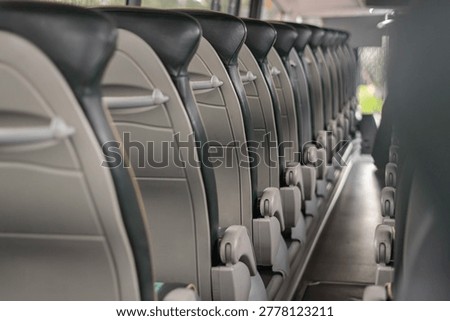 Empty Modern Bus Interior With Rows of Passenger Seats, Public Transport Background With Copy Space