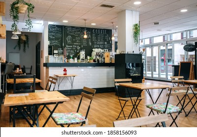 Empty modern cafe interior with chairs and tables