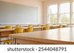 Empty modern classroom with chairs, desks and chalkboard.