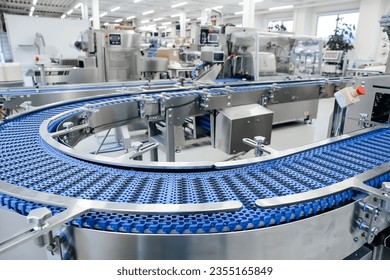 Empty modern conveyor belt of production line, part of industrial equipment in factory plant. Automatic system line - Powered by Shutterstock