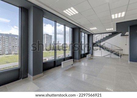empty modern hall room with columns, doors and panoramic windows.