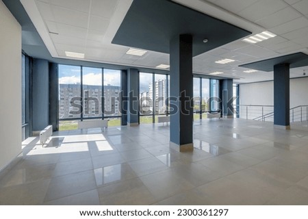 empty modern hall room with columns, doors and panoramic windows.