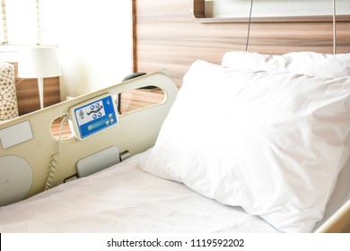 Empty modern hospital bed and comfortable medical equipped for patient in Hospital (Clinic or rehabilitation center) room.