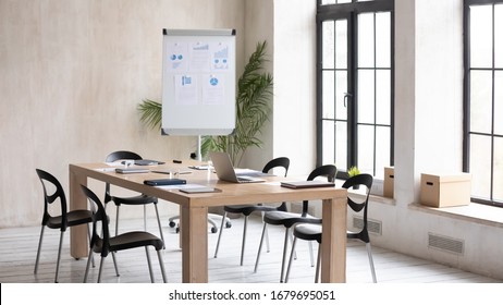 Empty Modern Loft Office Space With Wooden Table, Electronic Appliances Notebooks Ready For Meeting, Working Workplace With No People Prepared For Briefing, Whiteboard Presentation Or Training