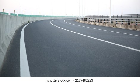 Empty Modern Road Interchange In City. A Curved Turn On The Road.