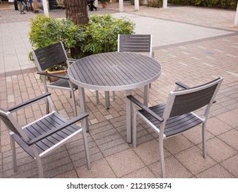 Empty Modern Steel Round Table And 4 Chairs And Green Plants In The Cafeteria Outside The Mall 