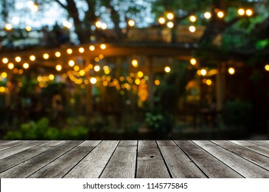 empty modern wooden terrace with abstract night light bokeh of night festival in garden, copy space for display of product or object presentation, vintage color tone