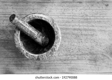 An Empty Mortar And Pestle From Above On A Timber Background