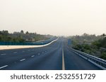 Empty motorway passing through hilly countryside landscape