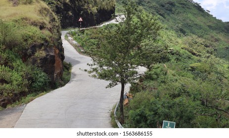 Empty Mountain Road With Lush Green Surrounding. Zig Zag Path On Hilly Terrain.