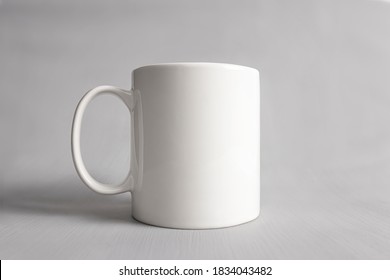 Empty Mug Mock-up, Close Up White Coffee Cub Isolated On Grey Background, Blank Front View Classic White Mug Mockup, Concept Branding Mock Up For Design Your Logo Design.