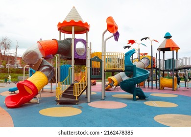 An empty multicolor playground with attractions. A place of rest and pastime for children in the yard next to the house.