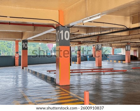 Empty Multi-Level Parking Lot with Numbered Colums