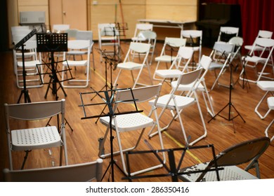 Empty Music Stand And Chairs On Stage. Selective Focus On Music Stand.