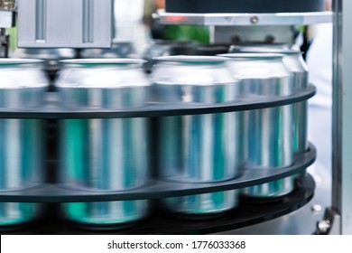 Empty New Aluminum Cans For Drink Process Are Moving In Factory Line On Conveyor Belt Machine At Beverage Manufacturing. Food And Beverage Industrial Business Concept.