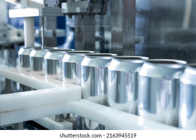 Empty new aluminum cans for drink process in factory line on conveyor belt machine at beverage manufacturing. food and beverage industrial business concept. High quality photo - Shutterstock ID 2163945519