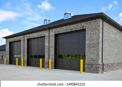 Empty New Brick Commercial Building with Three Large Garage Doors 
