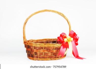 Empty New Year Vintage Basket Gift With Red-gold Ribbon Bow On Copy Space Background