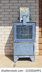 Empty Newspaper Vending Machine On Sidewalk Near Store Building