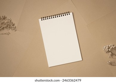 Empty notebook on sheets of paper background from above. Copy space