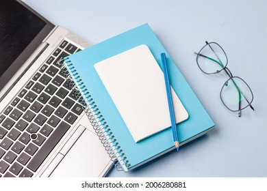 Empty notebook ready for mockup on blue table, top view, flatlay.