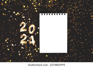 Empty notepad mockup, glowing stars confetti and 2024 golden numbers on a black background. New Year wish list concept. - Shutterstock ID 2274803995
