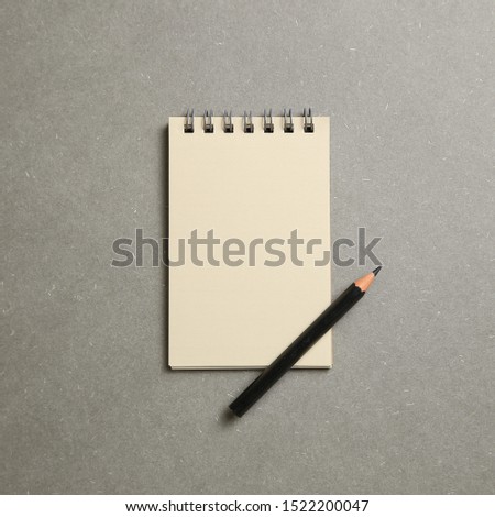Empty notepad on gray background