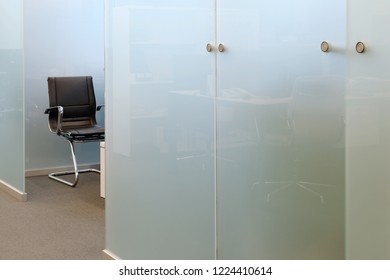 Empty Office Chair And Glass Partition Wall