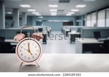 Empty office and Clock marking 5 pm. Concepts such as quiet quitting, coffee break or taking a break at work. Selective focus