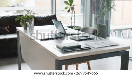 Empty office, laptop and tablet with documents for data analysis, stats review and financial growth. Desk, computer and digital tech with paperwork for research info, business report and investment.