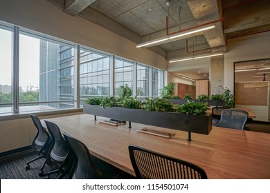 Empty Office With Original Concrete Ceiling And Wooden Furniture.