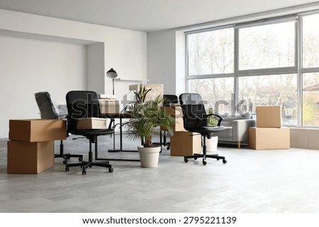 Empty office space with moving boxes and furniture, business relocation and new beginning