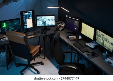 Empty office workspace featuring multiple computer monitors displaying surveillance footage and data analysis, ergonomic chairs positioned around desks, modern technology setup