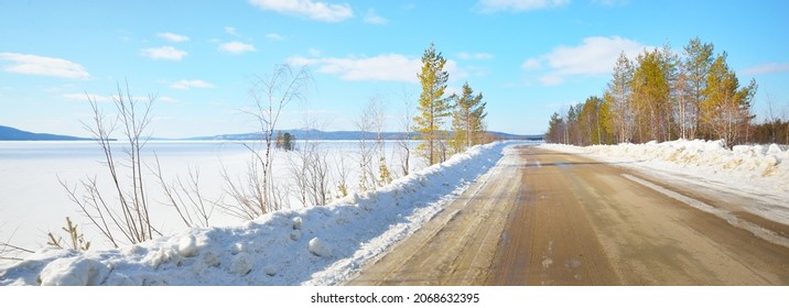 Empty Old Asphalt Road (highway) Through The Pine Forest. Snow-covered Mountains. Winter Landscape. Kola Peninsula, Polar Circle, Russia. Expedition, Work, Route, Logistics, Remote Places, Off-road