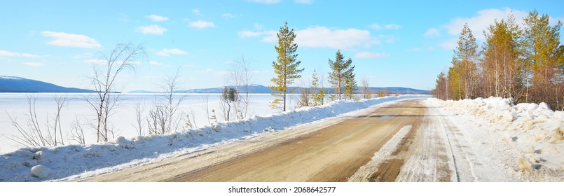 Empty Old Asphalt Road (highway) Through The Pine Forest. Snow-covered Mountains. Winter Landscape. Kola Peninsula, Polar Circle, Russia. Expedition, Work, Route, Logistics, Remote Places, Off-road